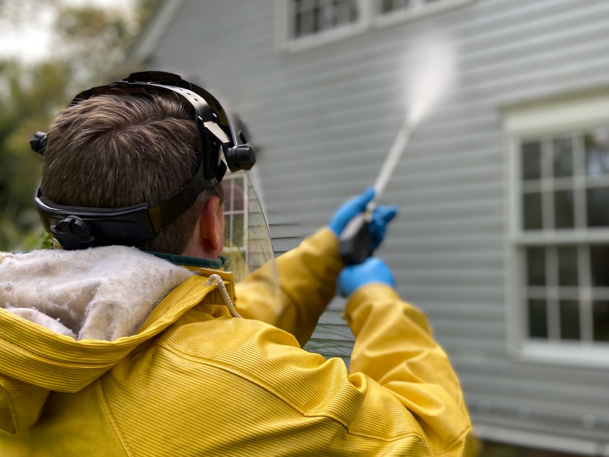 Freshly pressure-washed home exterior with a clean driveway